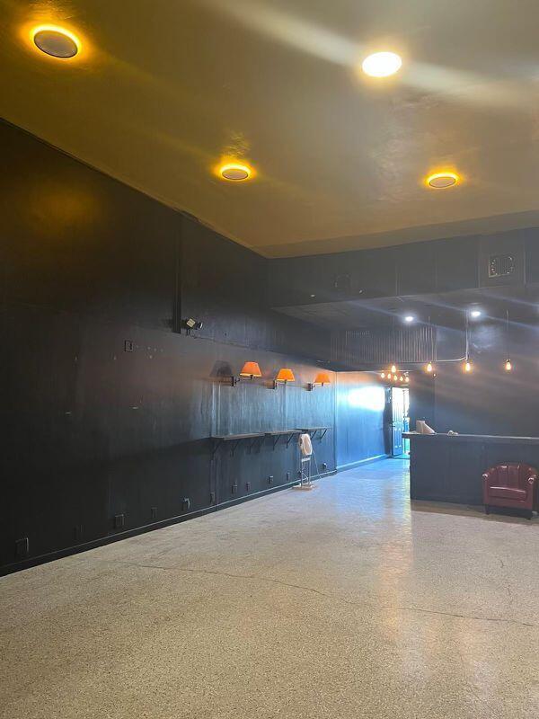 An empty commercial space features black walls, recessed ceiling lights, wall sconces, and concrete flooring — 924 71st Street, Miami Beach FL 33141, MIAMI BEACH, FL