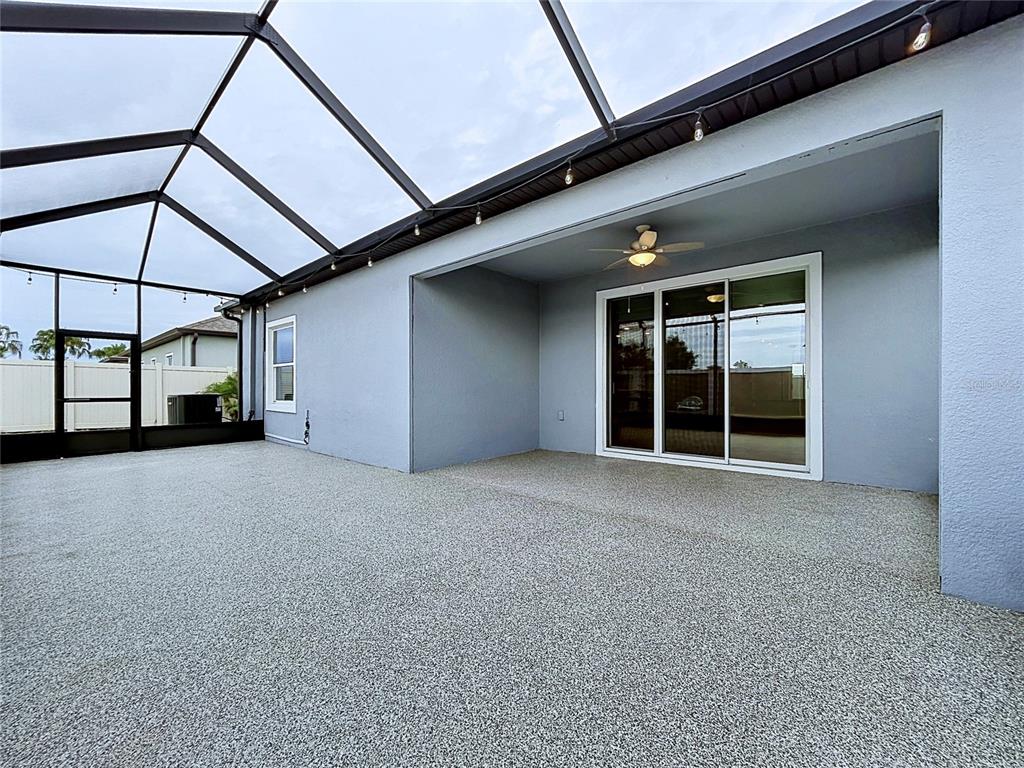 A long hallway with light-colored tile flooring and tray ceilings leads toward an open room — 11813 JUNE BRIAR LOOP, SAN ANTONIO, FL