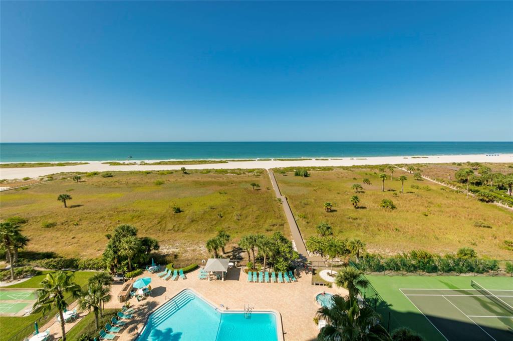 An aerial view of a beach, a swimming pool, and a tennis court — 1230 GULF BOULEVARD UNIT 306, CLEARWATER BEACH, FL