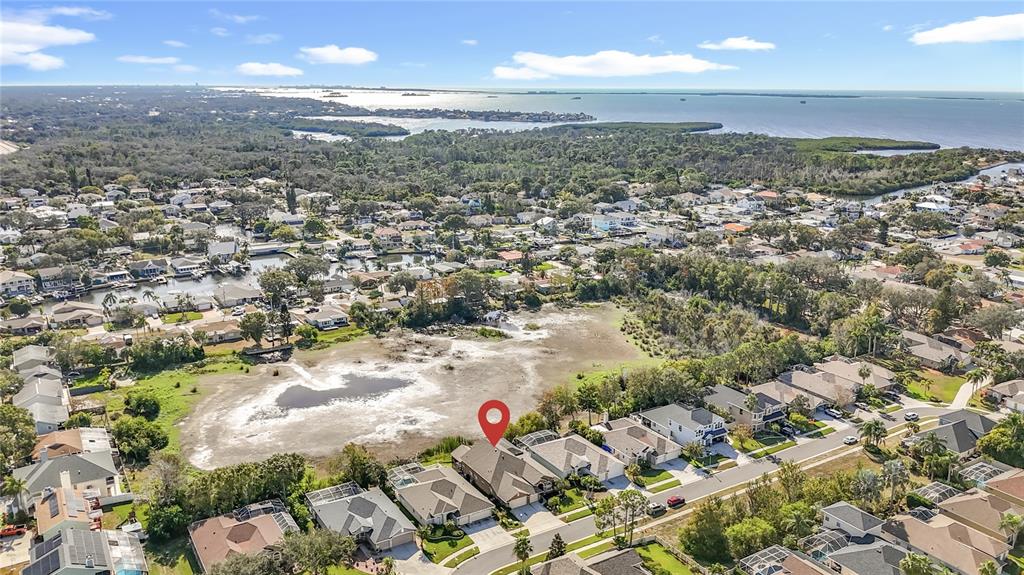 An aerial view shows a suburban neighborhood with a house marked by a red pin — 4961 W BREEZE CIRCLE, PALM HARBOR, FL