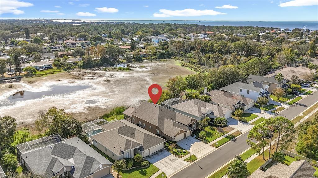 An aerial view shows a suburban house with a red location pin on its roof — 4961 W BREEZE CIRCLE, PALM HARBOR, FL