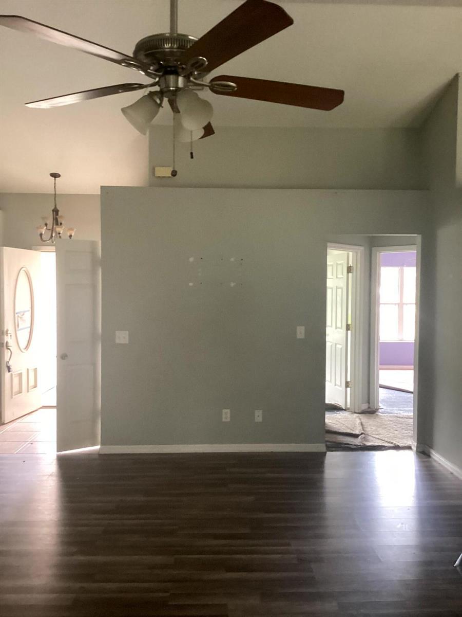 A living room with light gray walls, dark wood-look flooring, and a ceiling fan — 11880 SE 195th Place, FL 34431, FL
