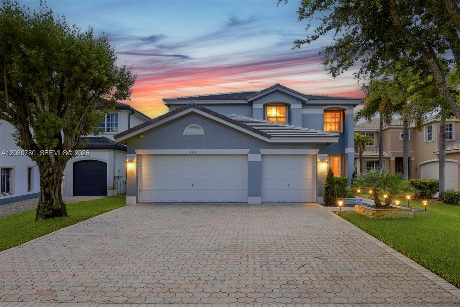 A kitchen features a dark blue island with gold hardware and white cabinets — 2576 SW 158th Ave, Miramar FL 33027, MIRAMAR, FL