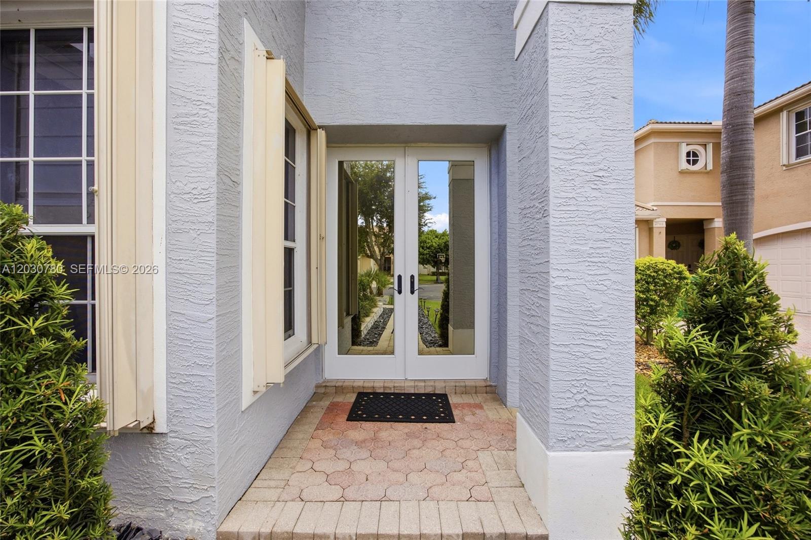 A front entryway features a double glass door, a paved porch, and light blue stucco walls — 2576 SW 158th Ave, Miramar FL 33027, MIRAMAR, FL