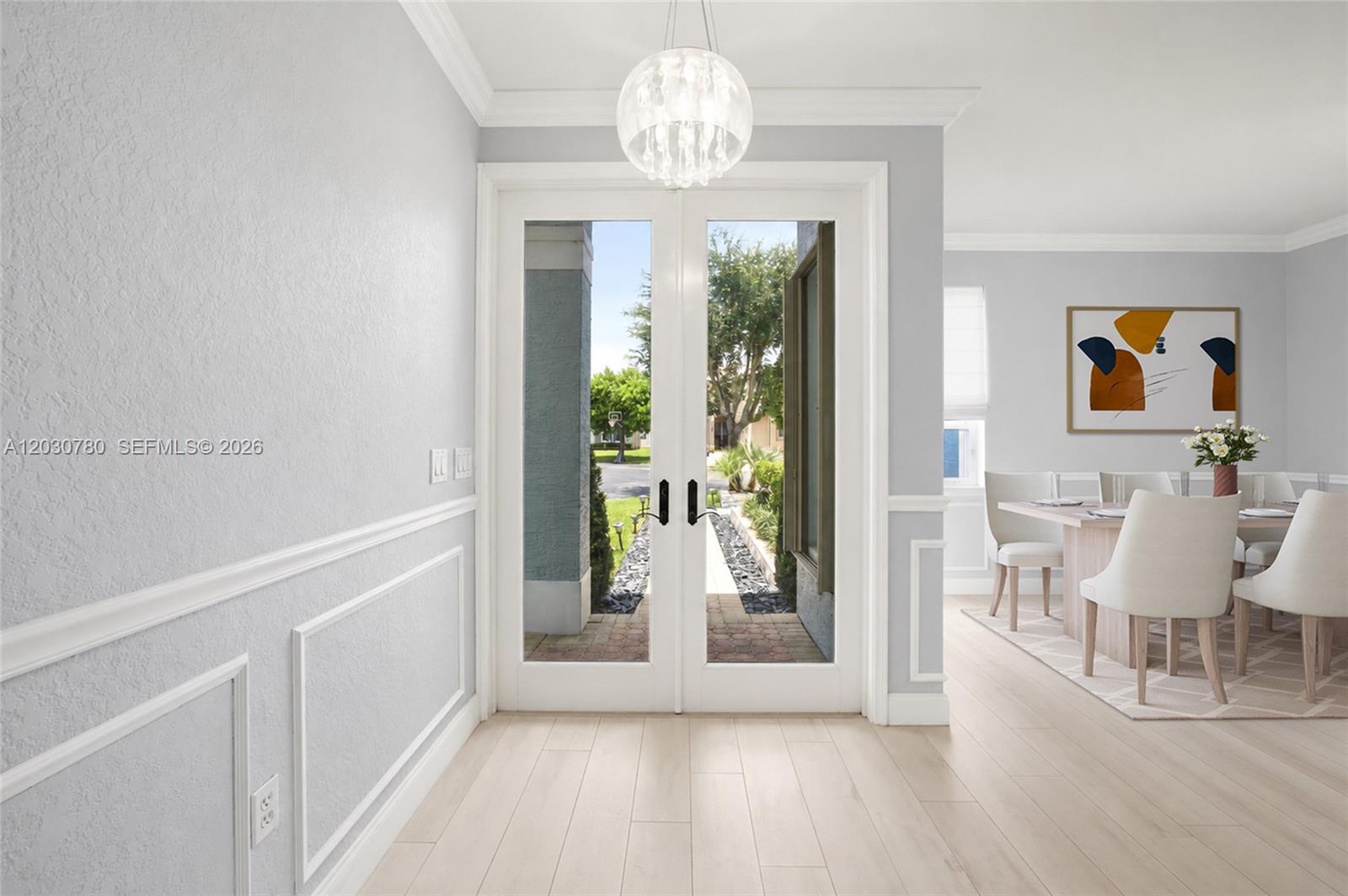 A bright entryway features light wood flooring, white wainscoting, and double glass doors — 2576 SW 158th Ave, Miramar FL 33027, MIRAMAR, FL