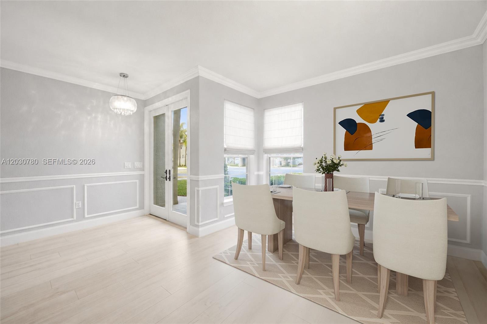 A dining room features light wood floors, wainscoting, a chandelier, and a glass-paneled door — 2576 SW 158th Ave, Miramar FL 33027, MIRAMAR, FL