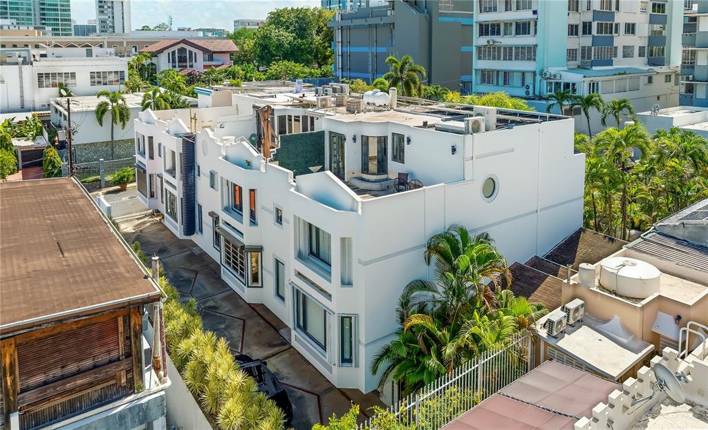 An aerial view shows a white multi-story building with a flat roof and palm trees — 552 WAYMOUTH STREET UNIT C, SAN JUAN, PR
