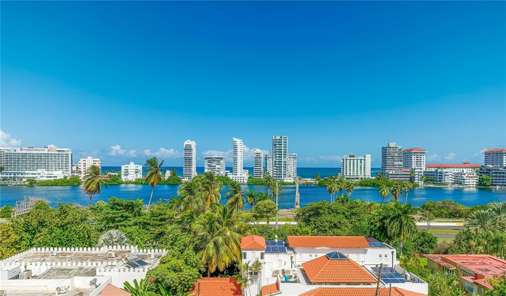 An elevated view of a coastal city skyline across a body of water with palm trees — 552 WAYMOUTH STREET UNIT C, SAN JUAN, PR