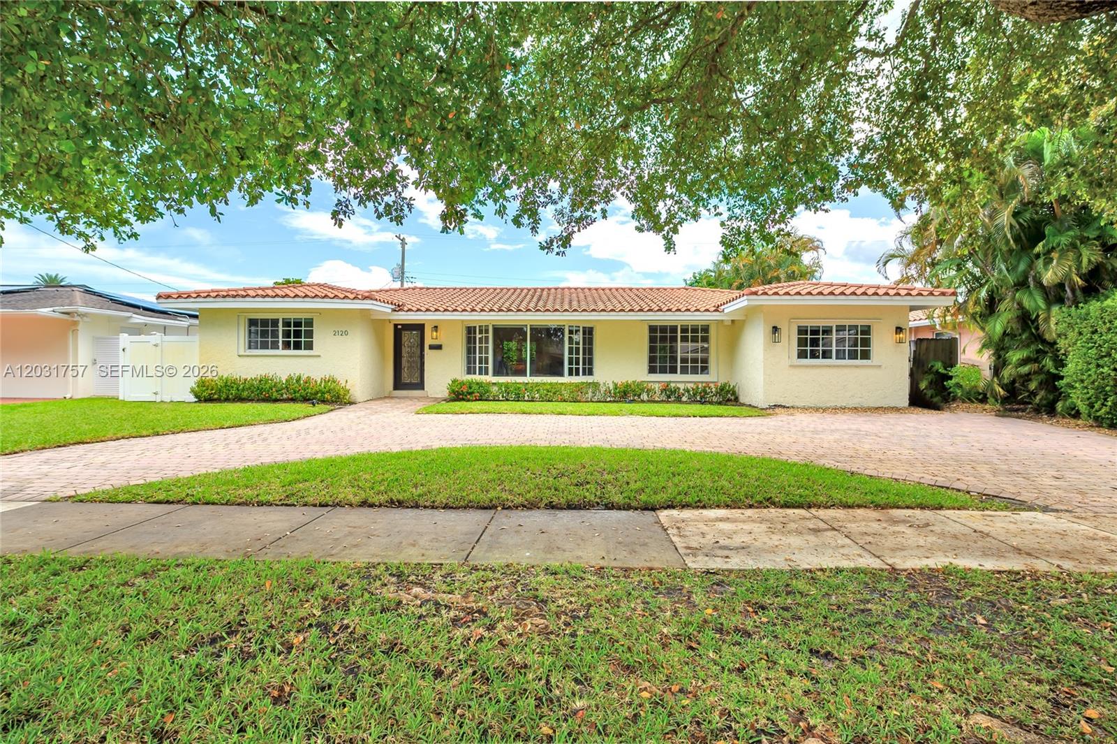 A single-story house with a yellow stucco exterior and a red tile roof — 2120 NE 207th St, Miami FL 33179, MIAMI, FL