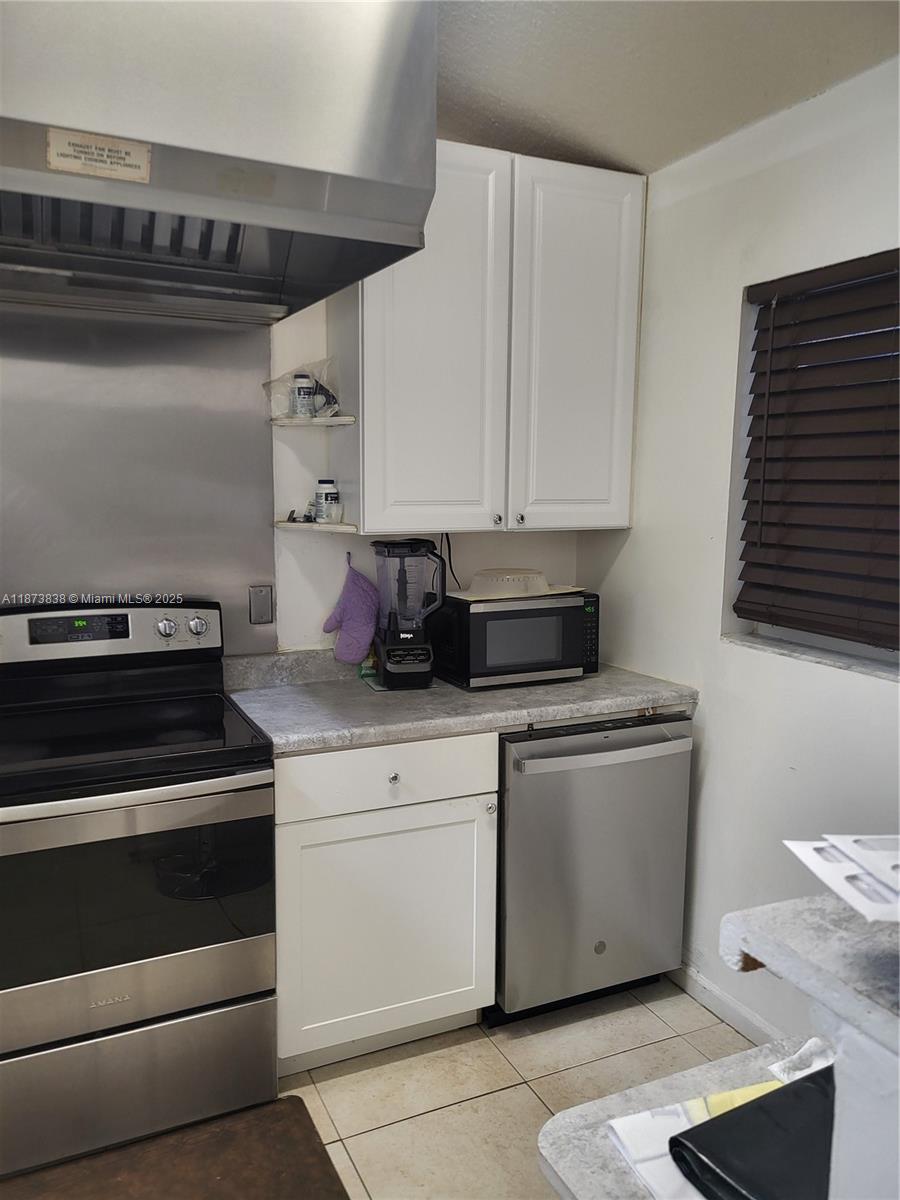 A kitchen features stainless steel appliances, white cabinets, and a gray laminate countertop — 3621 NW 90th Ter, Sunrise FL 33351, SUNRISE, FL