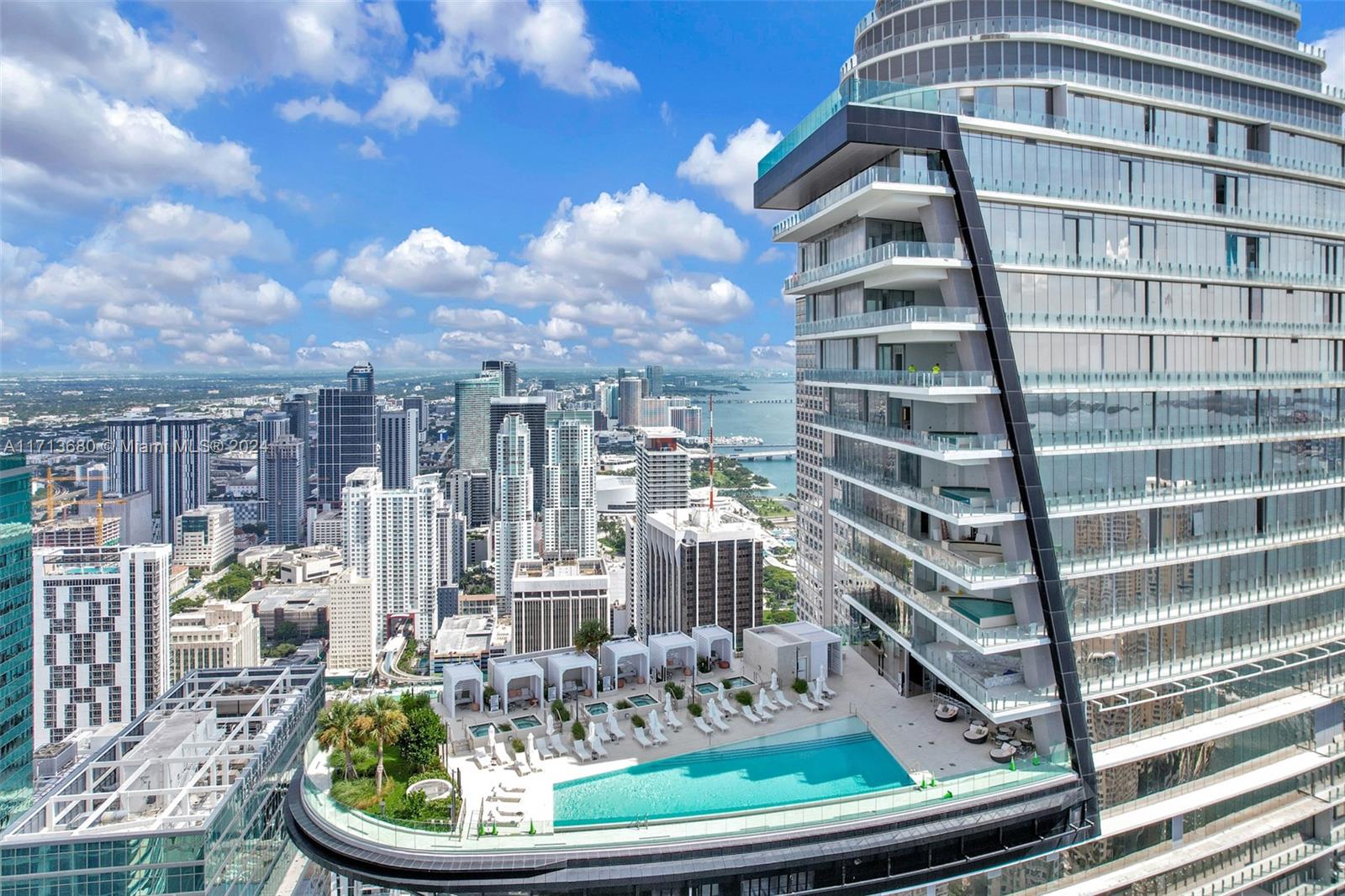 An aerial view of a high-rise building featuring an outdoor pool deck and city skyline — 300 Biscayne Blvd Way # 2608, Miami FL 33131, MIAMI, FL