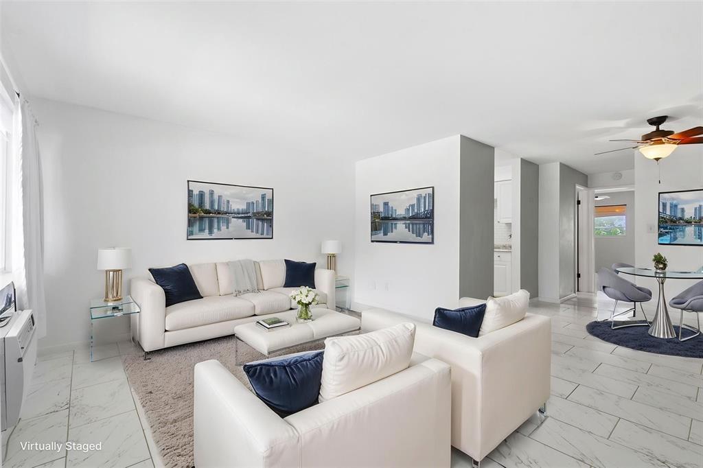 A living room with white furniture, a grey rug, and marble-style flooring — 2353 SHELLEY STREET UNIT 19, CLEARWATER, FL