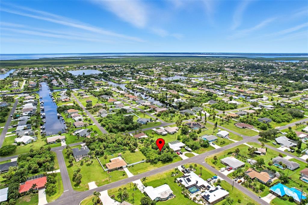 This aerial view shows a vacant, tree-covered residential lot marked by a red map pin — 18645 LAKE WORTH BOULEVARD, PORT CHARLOTTE, FL
