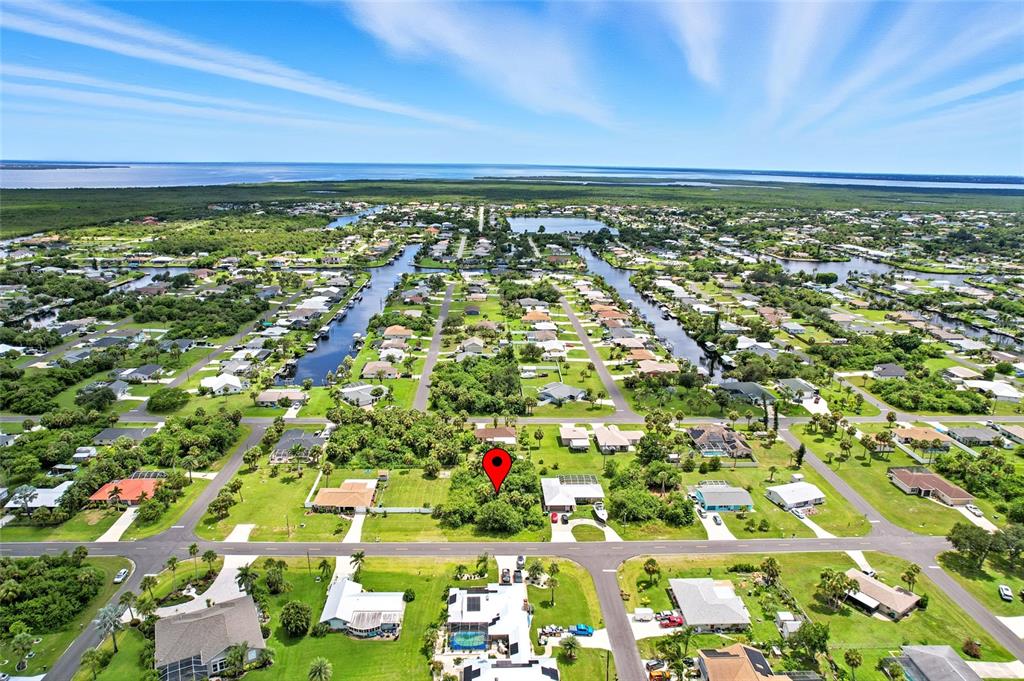 An aerial view shows a vacant, tree-covered residential lot marked by a red pin — 18645 LAKE WORTH BOULEVARD, PORT CHARLOTTE, FL
