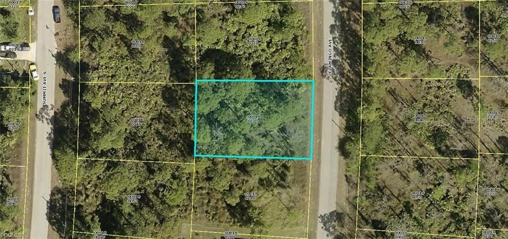 This is an aerial map showing a rectangular plot of land highlighted in blue — 512 FLAMINGO AVENUE, LEHIGH ACRES, FL