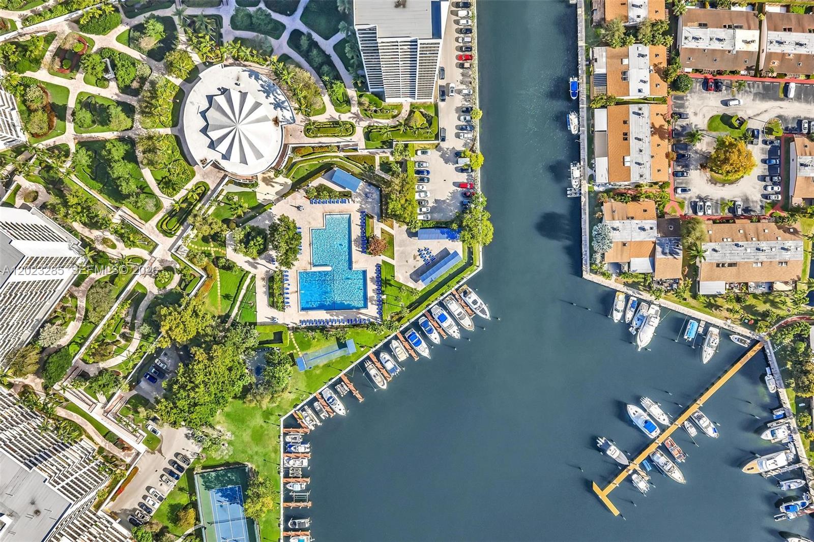 An aerial view shows a residential complex with a pool, marina, and landscaped grounds — 2500 Parkview Dr # 1514, Hallandale Beach FL 33009, HALLANDALE BEACH, FL