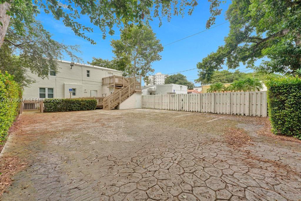 A paved parking lot sits in front of a two-story building with an exterior staircase — 1225 Alton Rd, Miami Beach FL 33139, MIAMI BEACH, FL