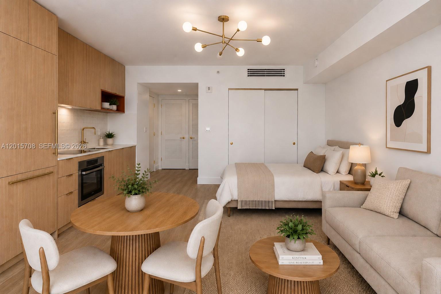 A studio apartment features a kitchen, dining area, and bedroom with light wood cabinetry — 90 NE 32nd # 313, Miami FL 33137, MIAMI, FL