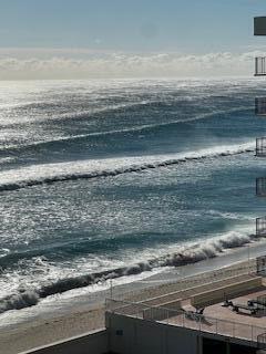 An elevated view of a sandy beach and ocean waves seen from a building balcony — 3450 S Ocean Boulevard # 712, Palm Beach FL 33480, PALM BEACH, FL