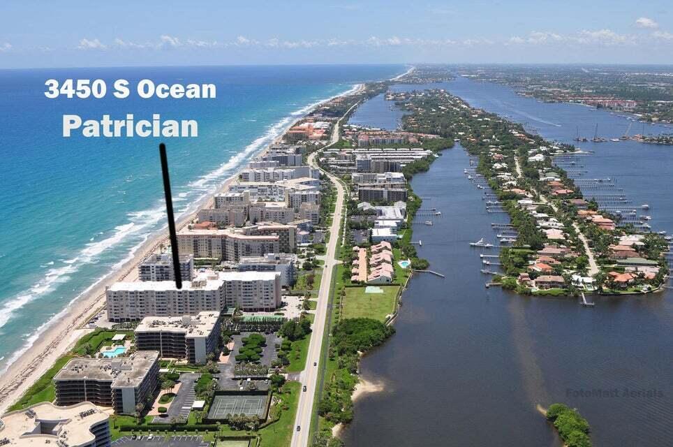 An aerial view shows a coastal condominium building situated between the ocean and a waterway — 3450 S Ocean Boulevard # 712, Palm Beach FL 33480, PALM BEACH, FL