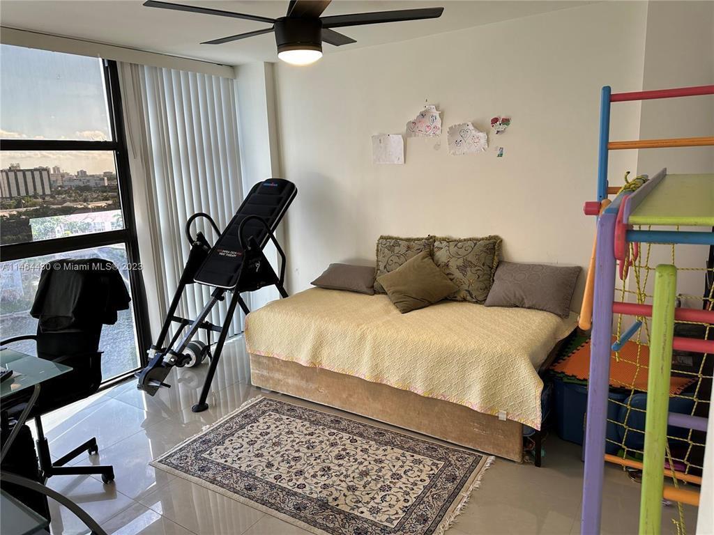 A room features a daybed, an inversion table, and a colorful indoor climbing structure — 200 Leslie Drive # 1128, Hallandale Beach FL 33009, HALLANDALE BEACH, FL