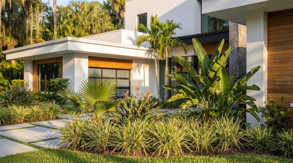 A modern house exterior features a white facade, wood accents, and a landscaped front garden — 9671 BLANDFORD ROAD, ORLANDO, FL
