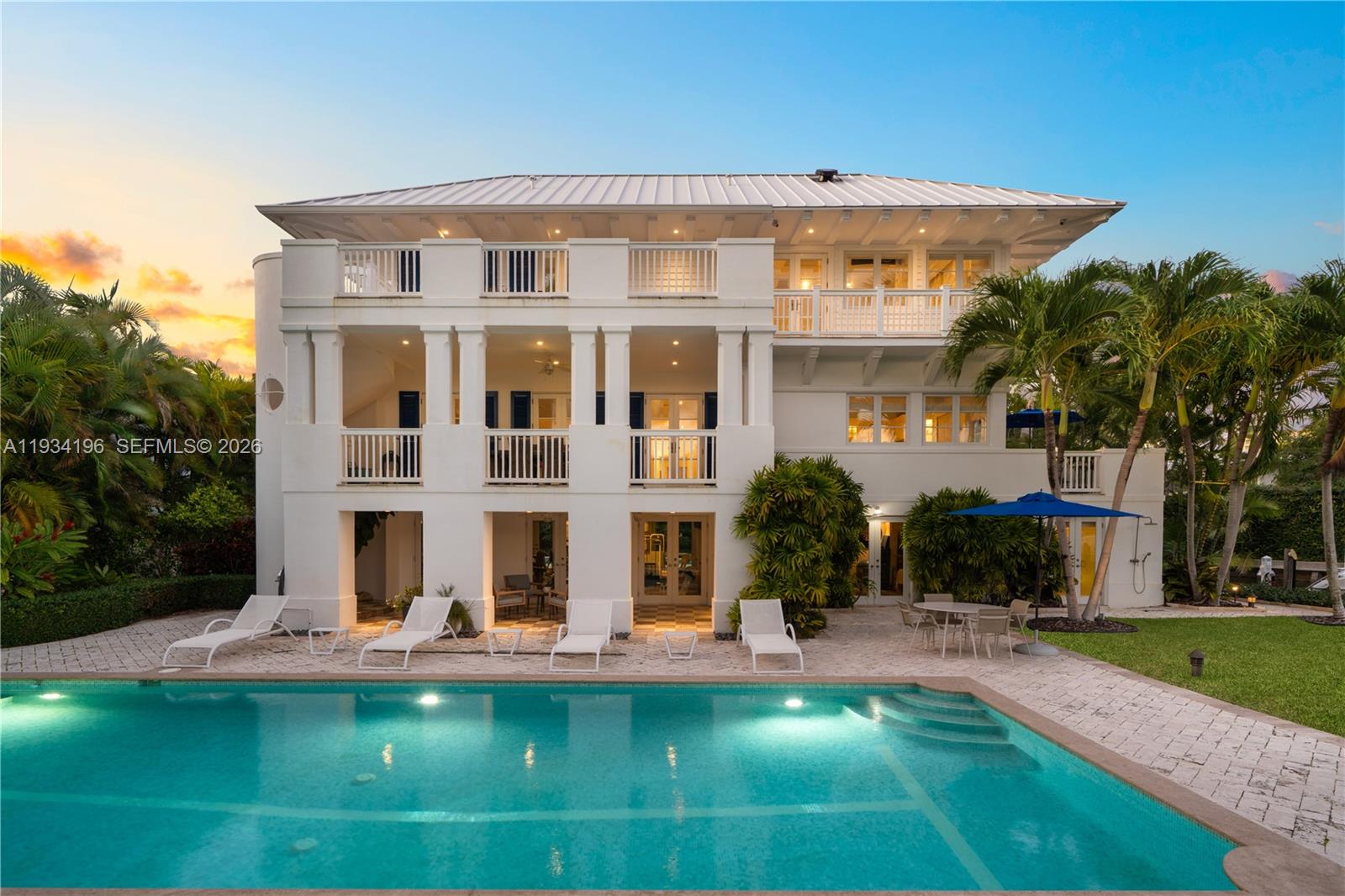 A three-story white house with balconies and a swimming pool in the backyard — 100 Cape Florida Dr, Key Biscayne FL 33149, KEY BISCAYNE, FL