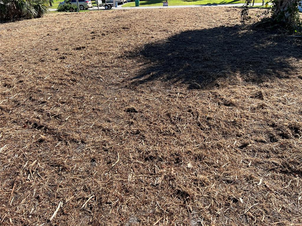 A vacant, cleared residential lot covered in dry grass and debris — 145 ROBINA STREET, PORT CHARLOTTE, FL