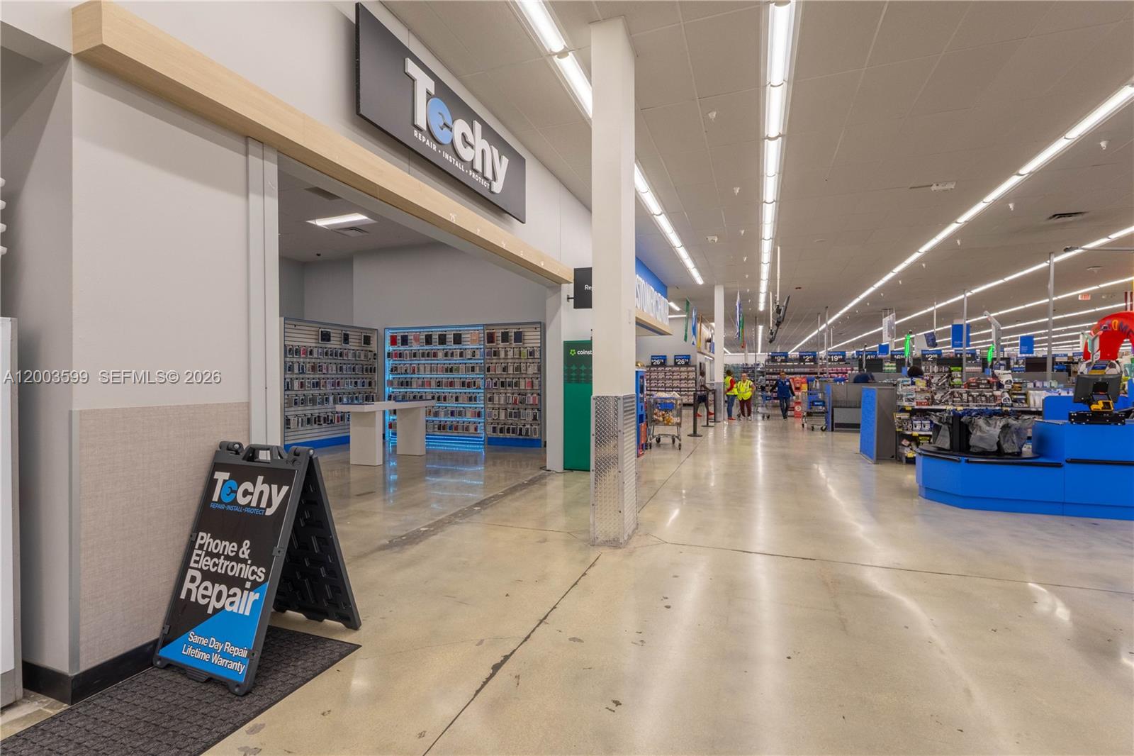 A Techy electronics repair kiosk is located inside a large retail store with concrete floors — 1800 S University Dr, Miramar FL 33025, MIRAMAR, FL