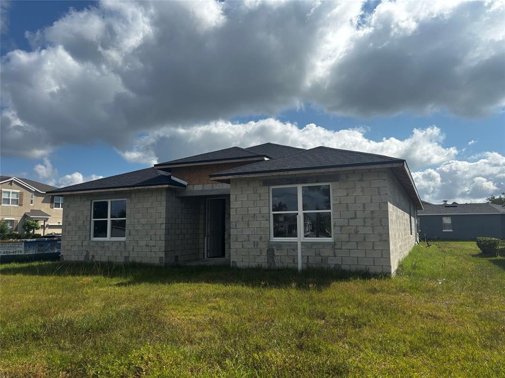 A single-story house under construction with concrete block walls and a shingled roof — 2651 TRAFALGAR BOULEVARD, KISSIMMEE, FL