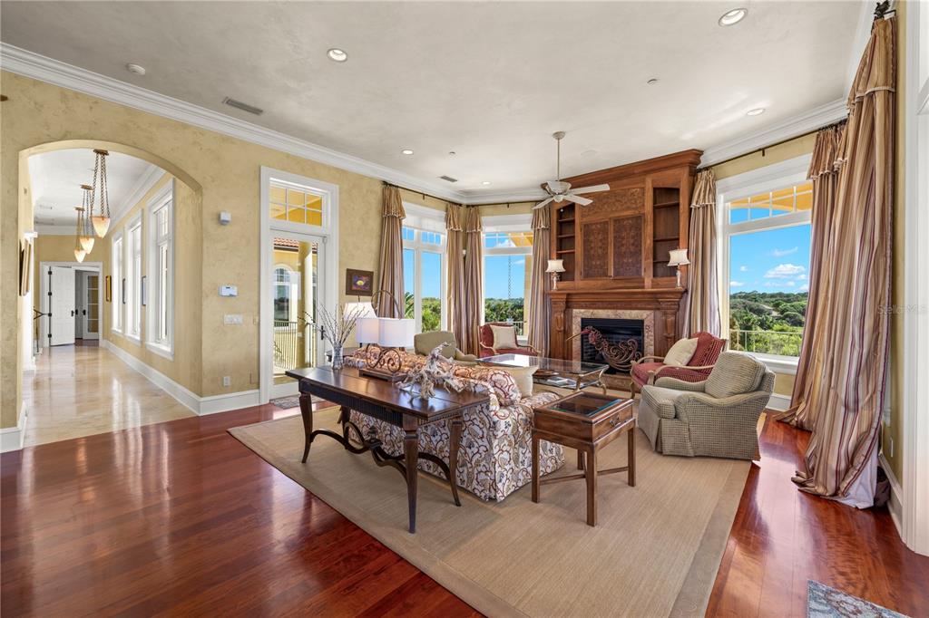 A kitchen with a dark wood island and granite countertops overlooks an adjacent living area — 501 GRANADA DRIVE, PALM COAST, FL