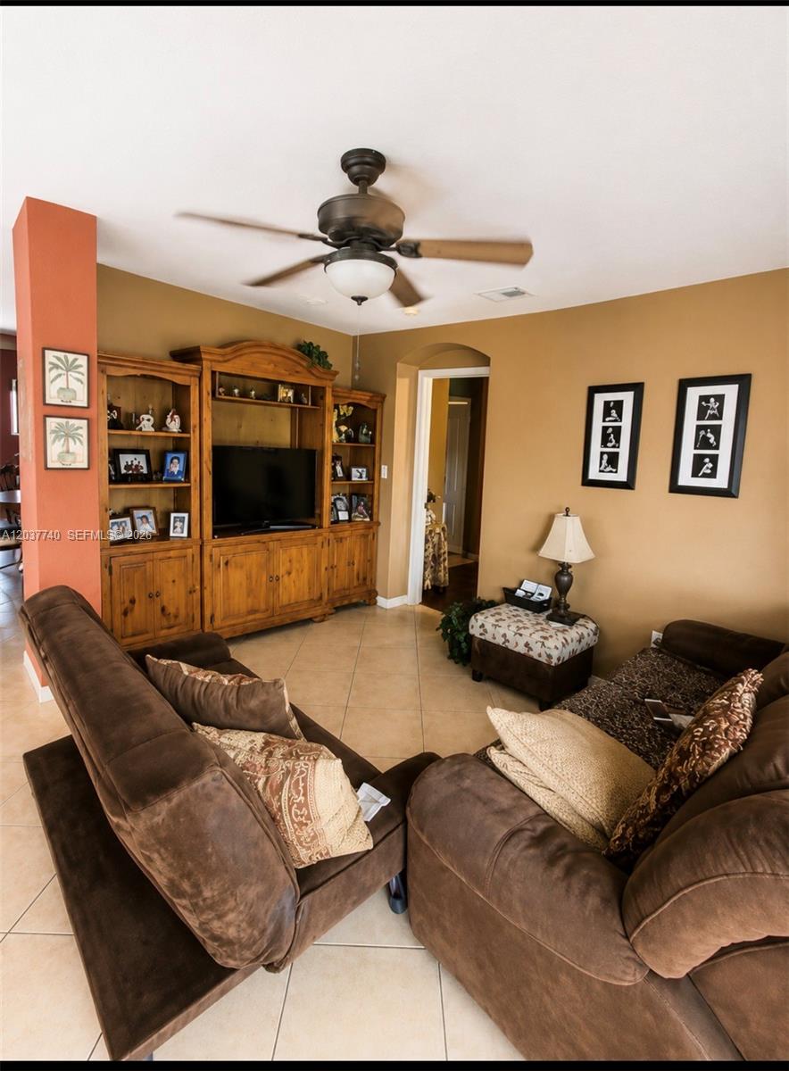 A living room features brown sofas, a wooden entertainment center, and tan walls — 16355 SW 46th Ter # 16355, Miami FL 33185, MIAMI, FL