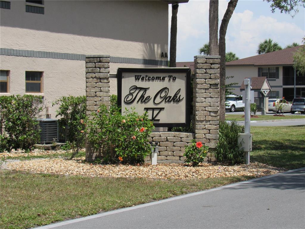 A brick monument sign welcomes visitors to The Oaks IV apartment complex — 19505 QUESADA AVENUE UNIT PP101, PORT CHARLOTTE, FL