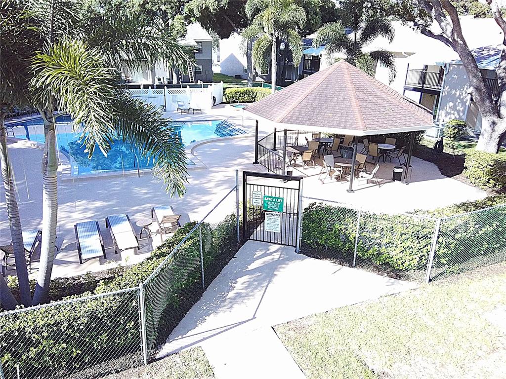An aerial view shows a swimming pool, a covered gazebo, and lounge chairs — 3808 N OAK DRIVE UNIT U42, TAMPA, FL
