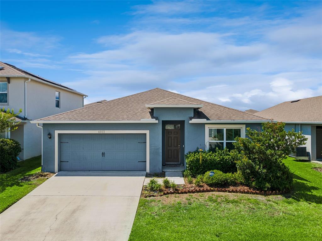 A single-story house with a gray exterior, a two-car garage, and a brown shingled roof — 4013 SILVERSTREAM TERRACE, SANFORD, FL