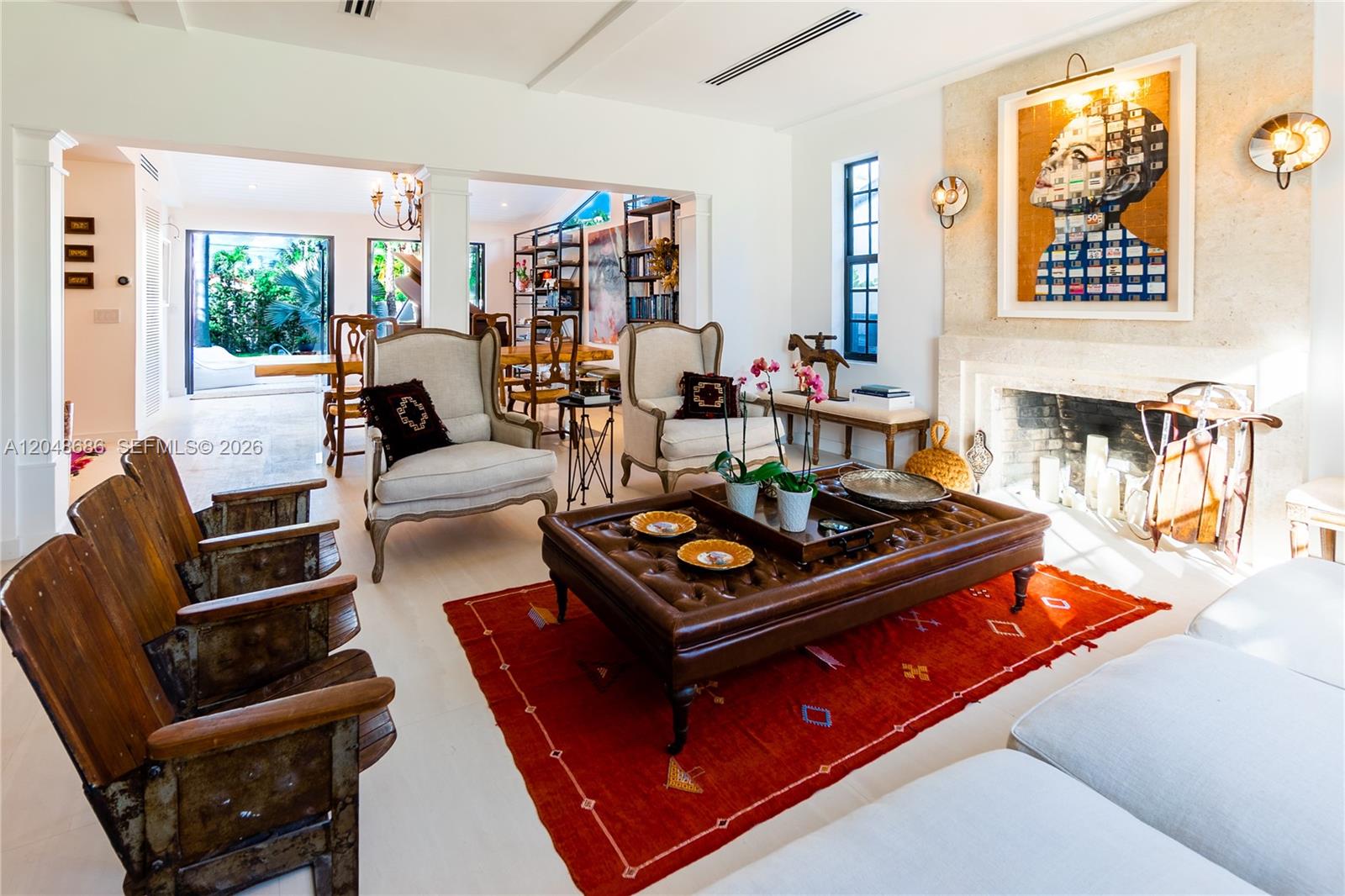 A living room features a leather ottoman, two armchairs, vintage theater seats, and a fireplace — 255 PALM AVENUE, Miami Beach FL 33139, MIAMI BEACH, FL