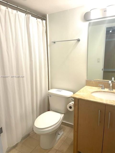 A kitchen with light wood cabinets and dark countertops overlooks an adjacent living area — 10275 Collins Ave # 201, Bal Harbour FL 33154, BAL HARBOUR, FL