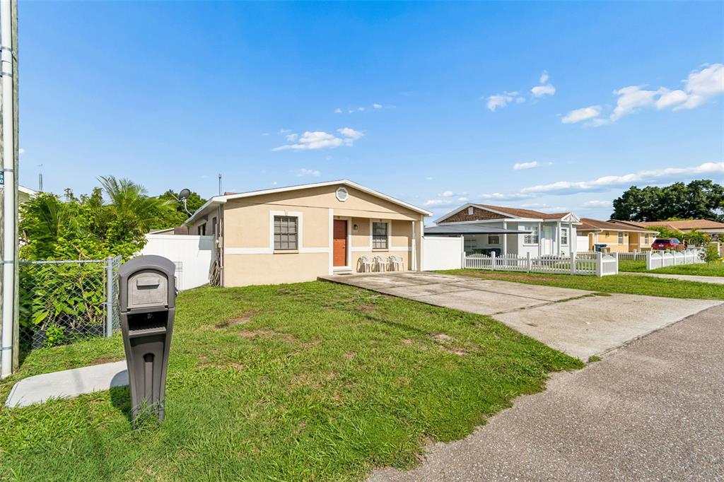 A single-story house with a concrete driveway and a mailbox in the front yard — 5120 N MATANZAS AVENUE, TAMPA, FL