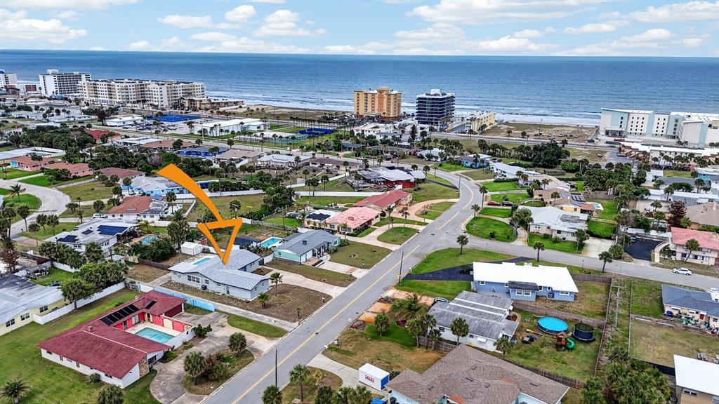 An aerial view shows a residential neighborhood near the beach with a highlighted house — 1027 BEL AIRE DRIVE, DAYTONA BEACH, FL