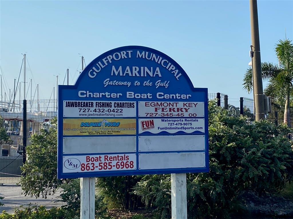 A blue sign for the Gulfport Municipal Marina stands outdoors near a boat dock — 2800 TIFTON ST UNIT 3, GULFPORT, FL