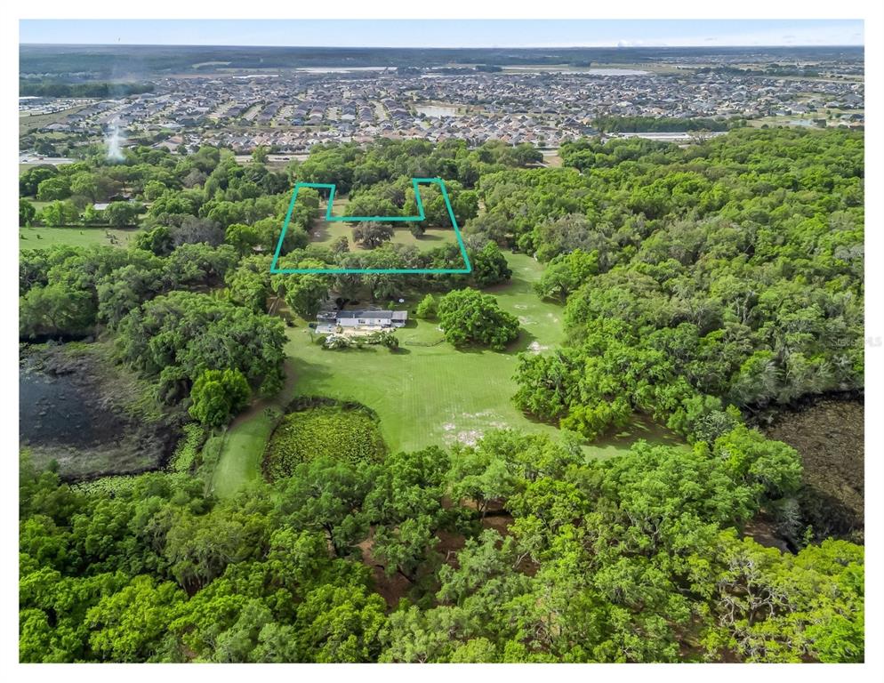 An aerial view shows a house on a large, wooded lot with a highlighted boundary — 747 COUNTY ROAD 466A, FRUITLAND PARK, FL