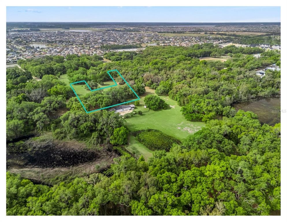 An aerial view shows a house on a large, wooded lot with a highlighted boundary — 747 COUNTY ROAD 466A, FRUITLAND PARK, FL