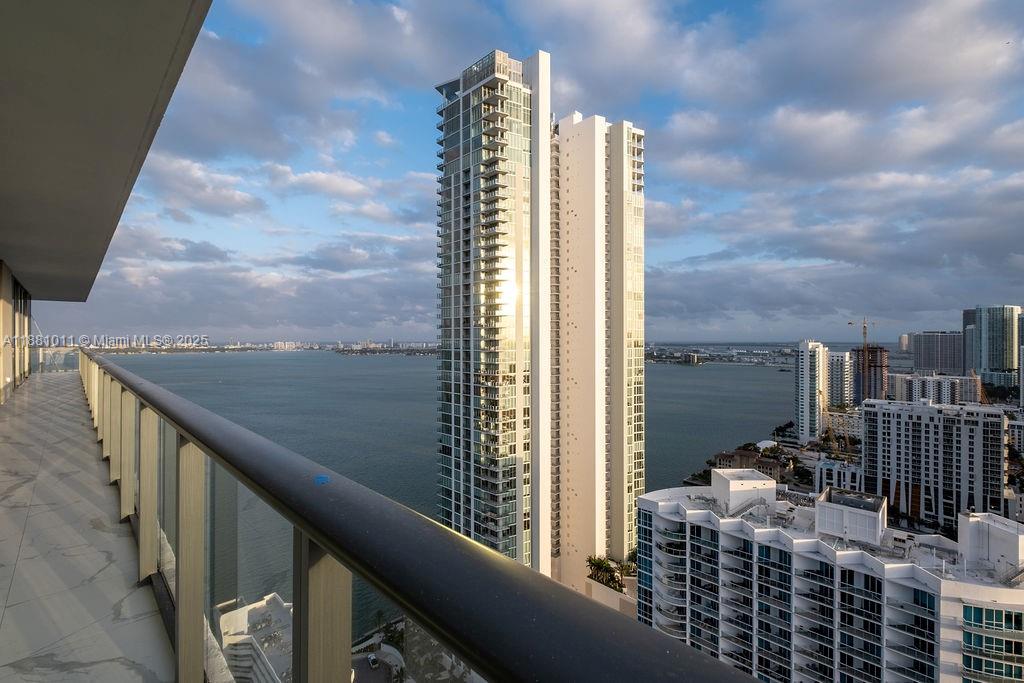 A high-rise balcony overlooks a large body of water and neighboring skyscrapers in Miami — 480 NE 31 St # 3101, Miami FL 33137, MIAMI, FL