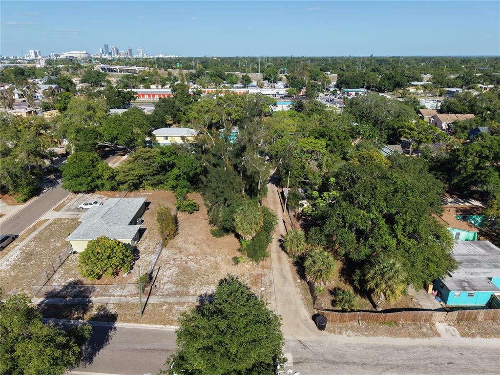 An aerial view shows a residential lot with trees, a house, and a dirt driveway — 14TH AVENUE S, ST PETERSBURG, FL