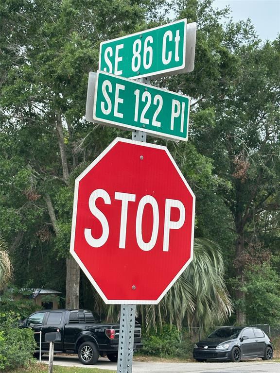 A stop sign stands below street signs for SE 86 Ct and SE 122 Pl — SE 86TH COURT, BELLEVIEW, FL