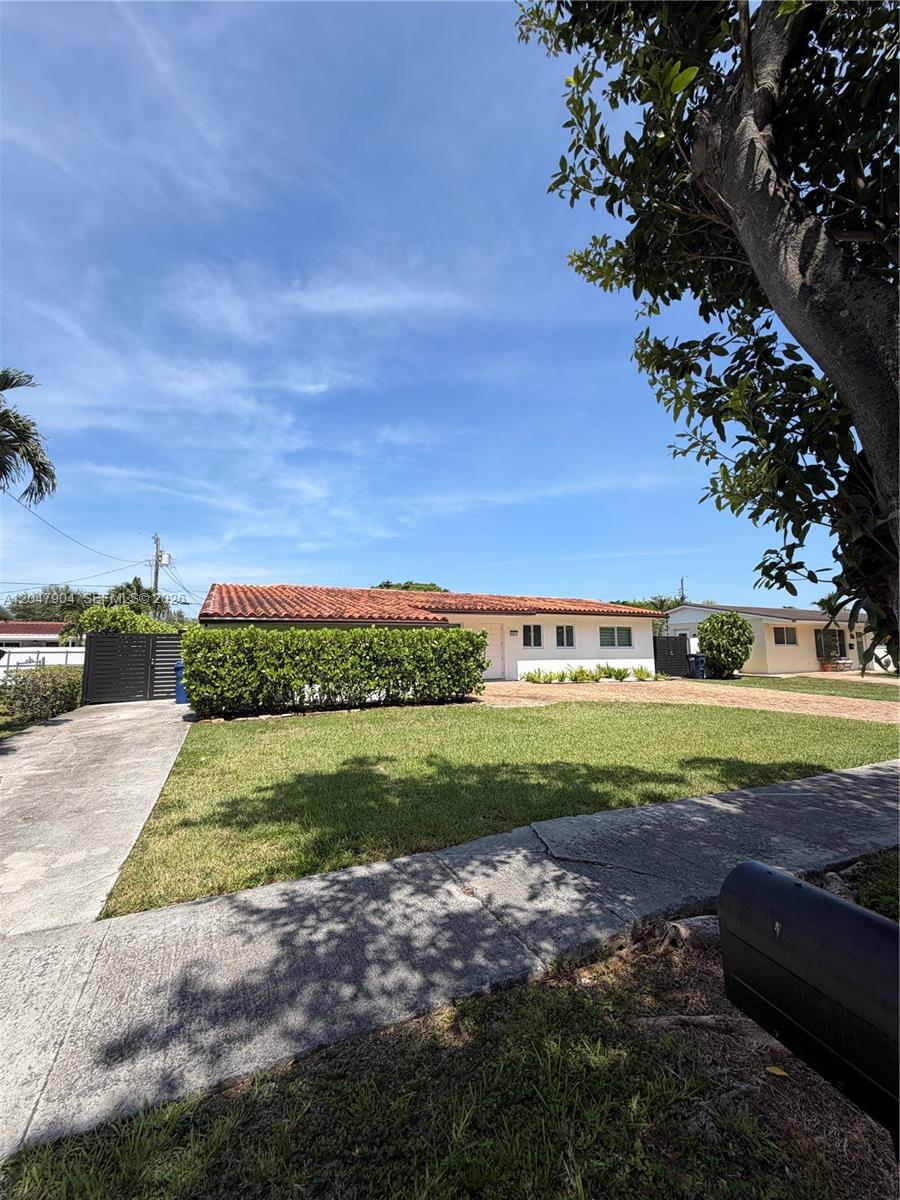A single-story house with a red tile roof and a large hedge in the front — 4401 SW 102nd Pl, Miami FL 33165, MIAMI, FL