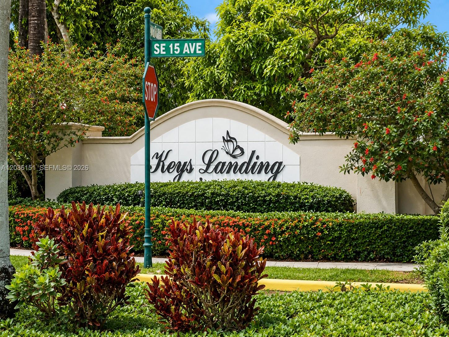 A sign for Keys Landing stands behind a manicured hedge and a stop sign — 1611 SE 16th St, Homestead FL 33035, HOMESTEAD, FL