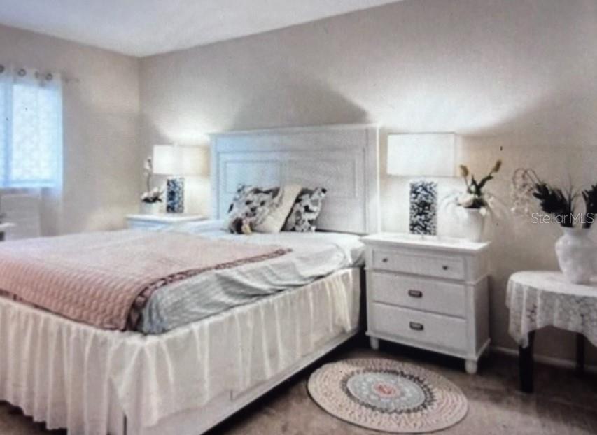 A bedroom features a white bed frame, two matching nightstands with lamps, and a small table — 3224 MOUNT HOPE STREET, NORTH PORT, FL