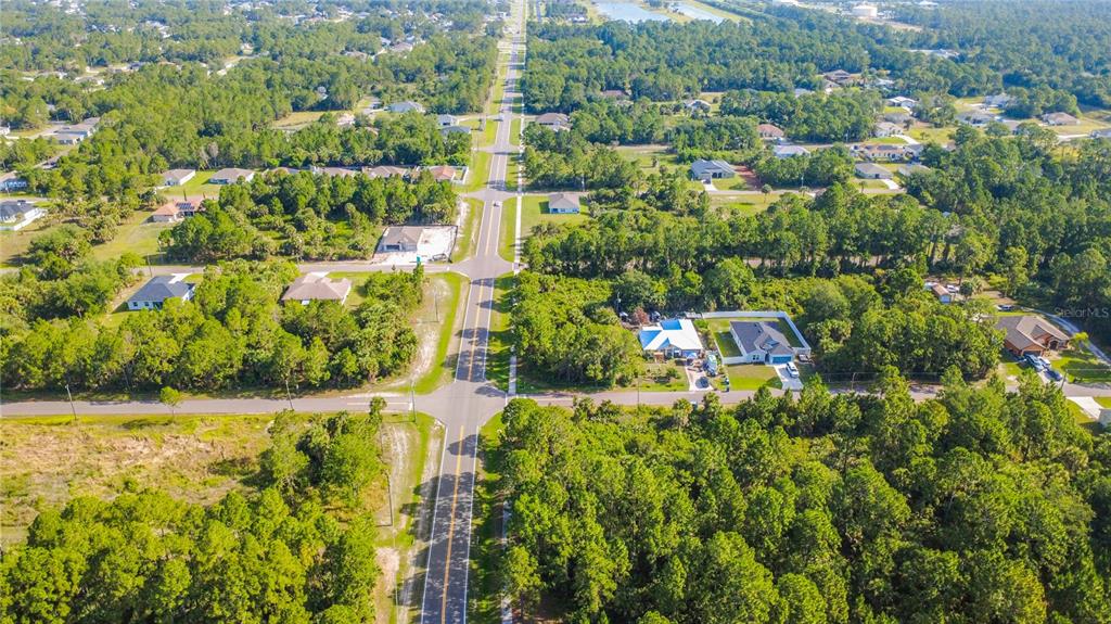An aerial view shows a residential neighborhood with houses scattered among dense green trees — 0 DEGROODT ROAD SW, PALM BAY, FL