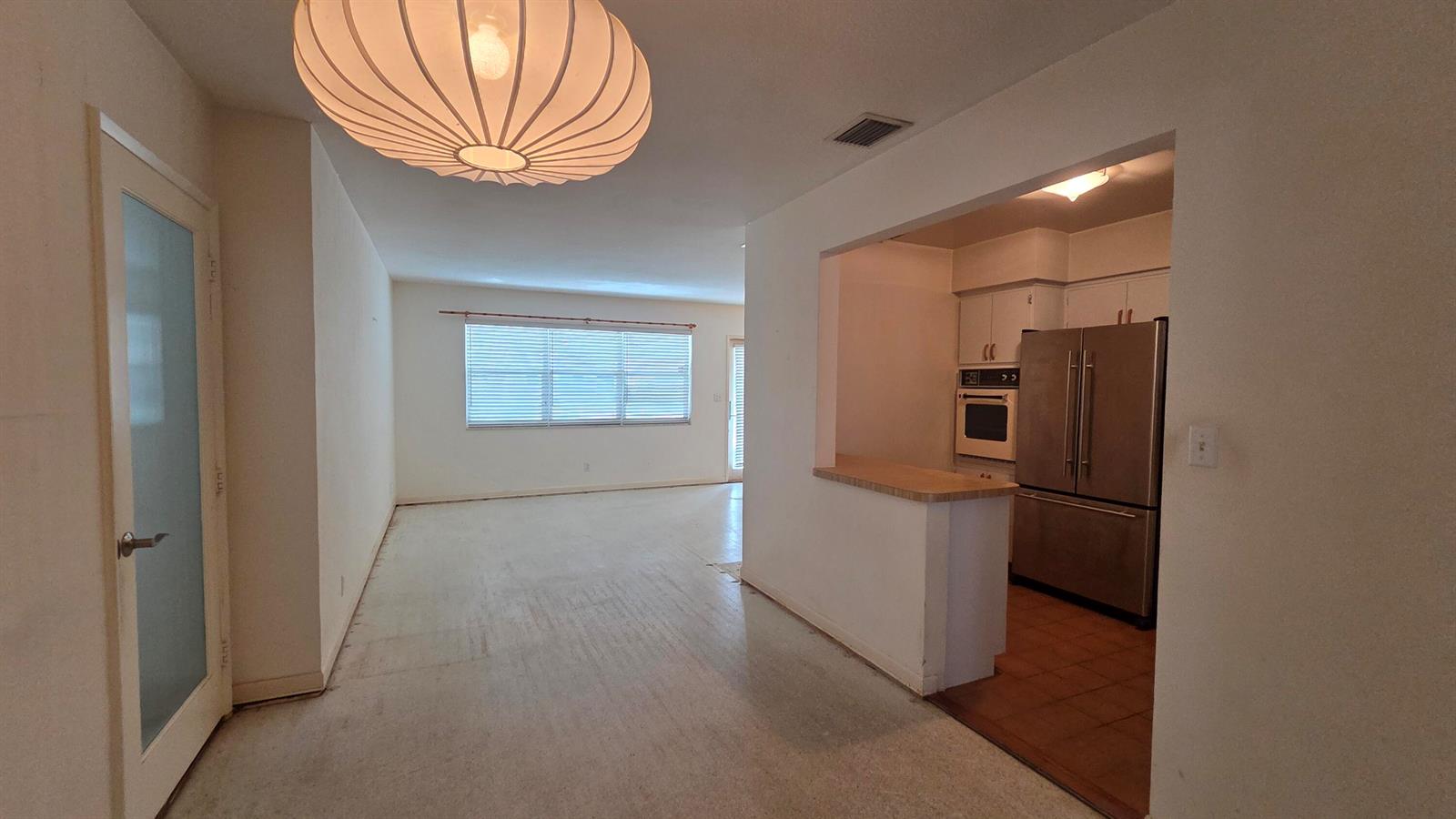 A view of an open-concept living area with a kitchen featuring stainless steel appliances — 2000 N 31st Avenue, Hollywood FL 33021, HOLLYWOOD, FL